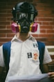 boy wearing black gas mask while standing