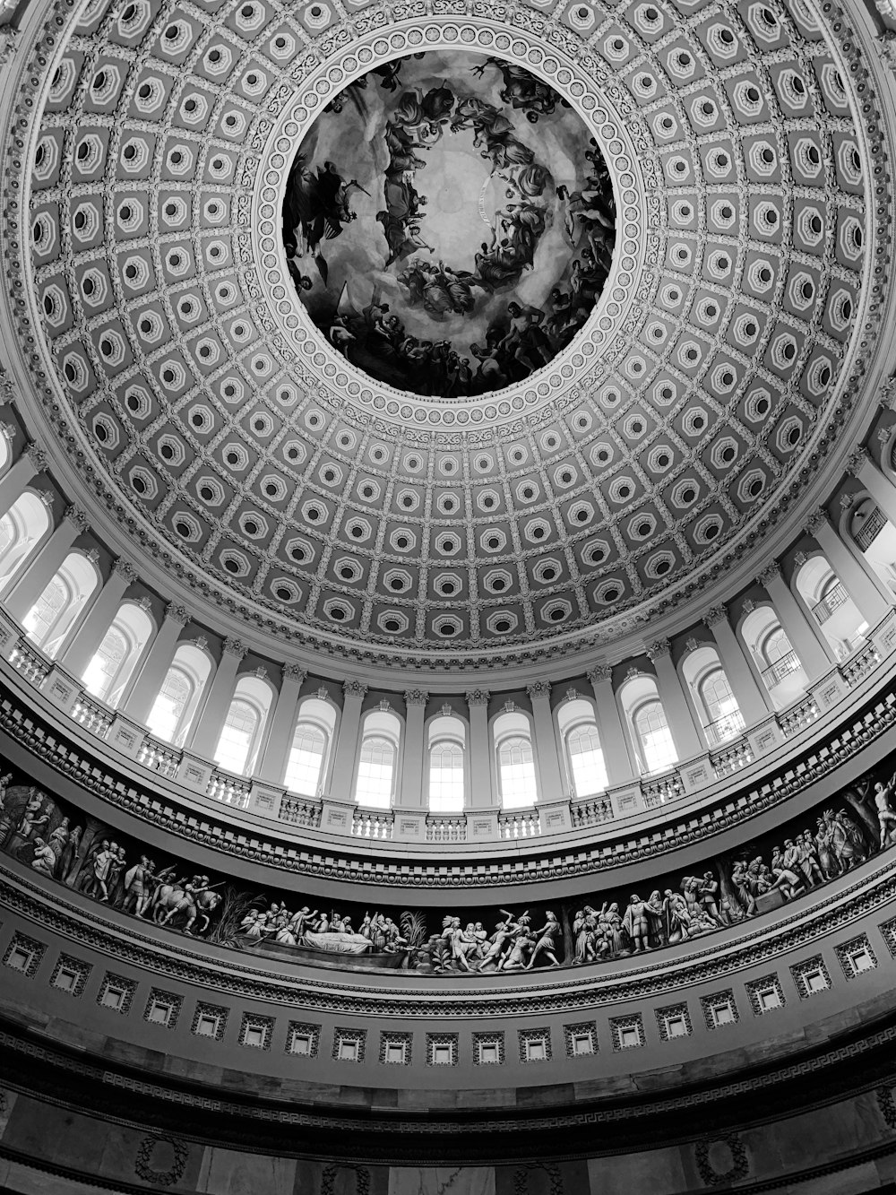 grayscale low-angle photography of dome cathedral ceiling interior