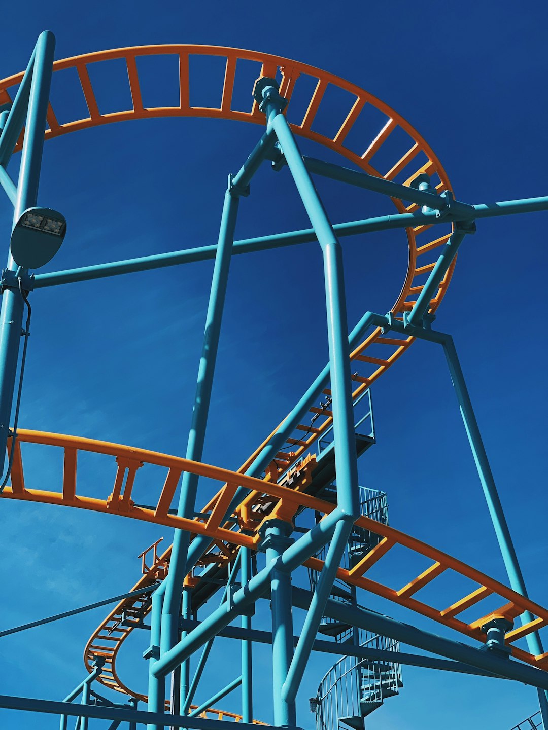 blue and orange amusement ride during daytime