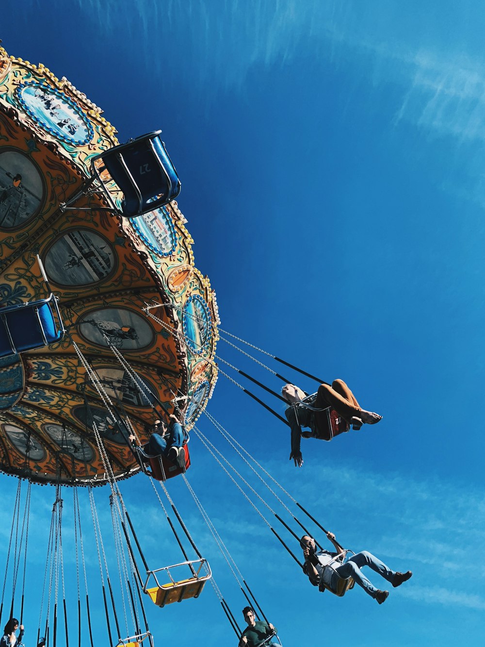 a group of people riding on top of a carnival ride