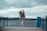 woman standing on dock and bending her body during daytime
