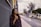 woman leaning on gray wall looking up
