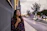 woman leaning on gray wall looking up