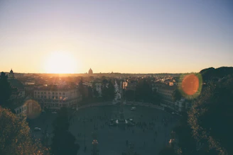 A panoramic view of an open-world game’s sprawling city at sunset