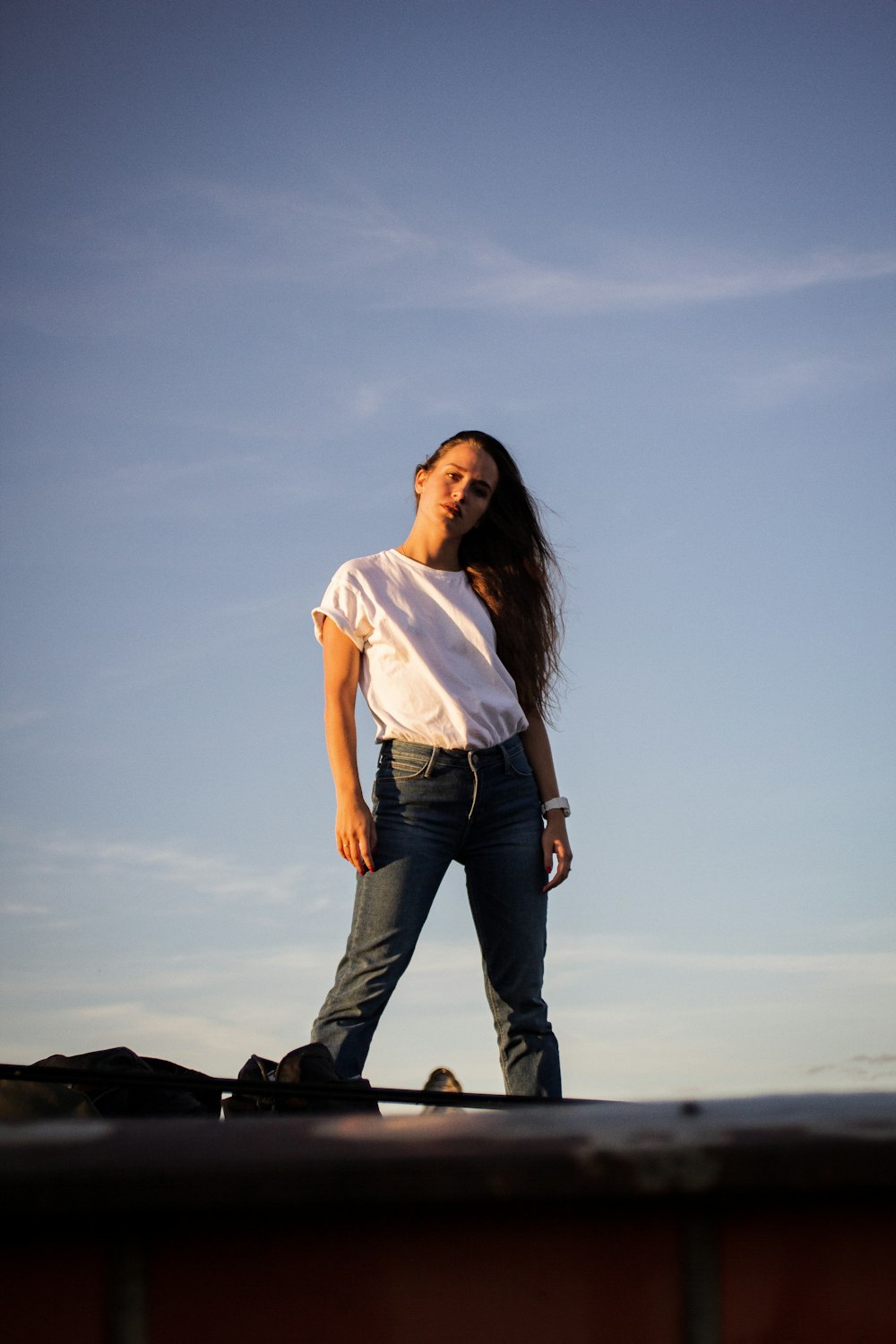 standing woman in white shirt