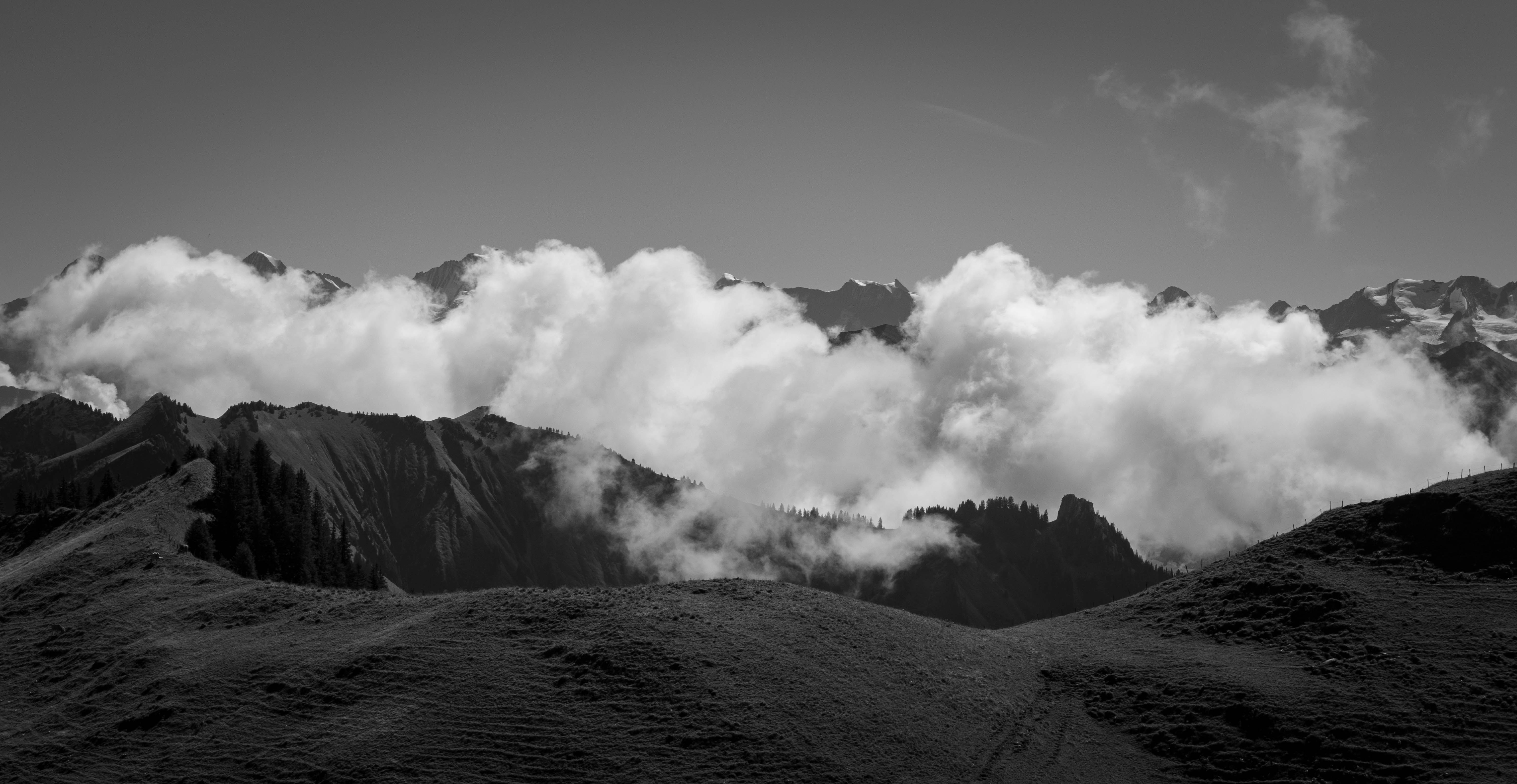 grayscale photo of clouds on mountain