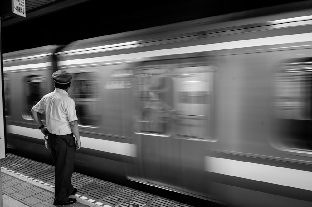 man standing beside train