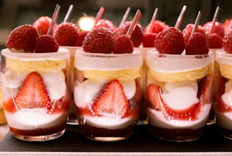 Delicate cups filled with layered mousse desserts topped with fresh berries