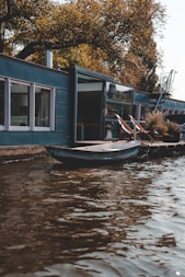 blue jon boat on body of water