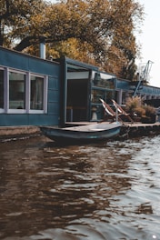 blue jon boat on body of water