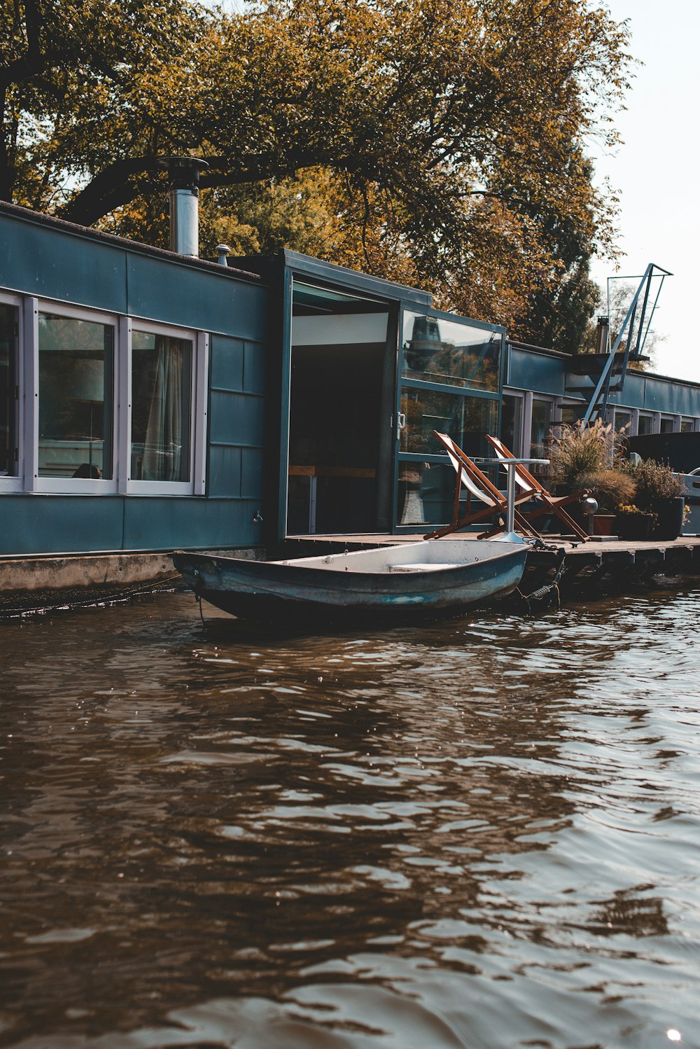 blue jon boat on body of water