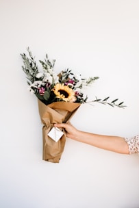 person holding bouquet of flowers