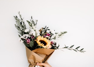 person holding bouquet of flowers