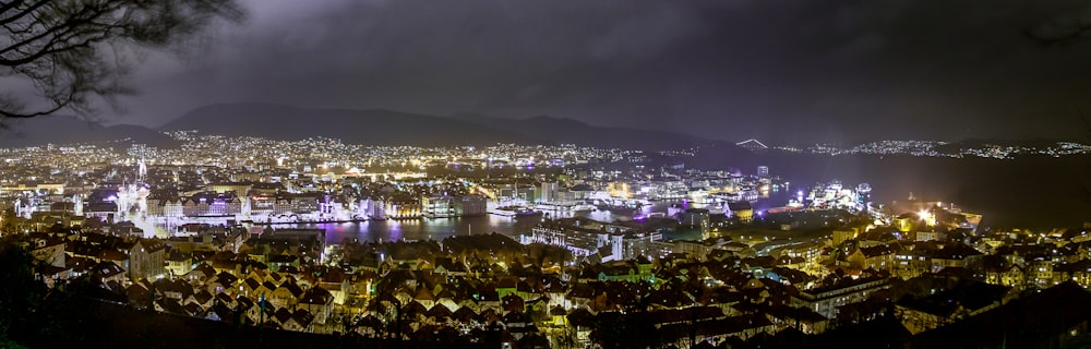 a view of a city at night from the top of a hill