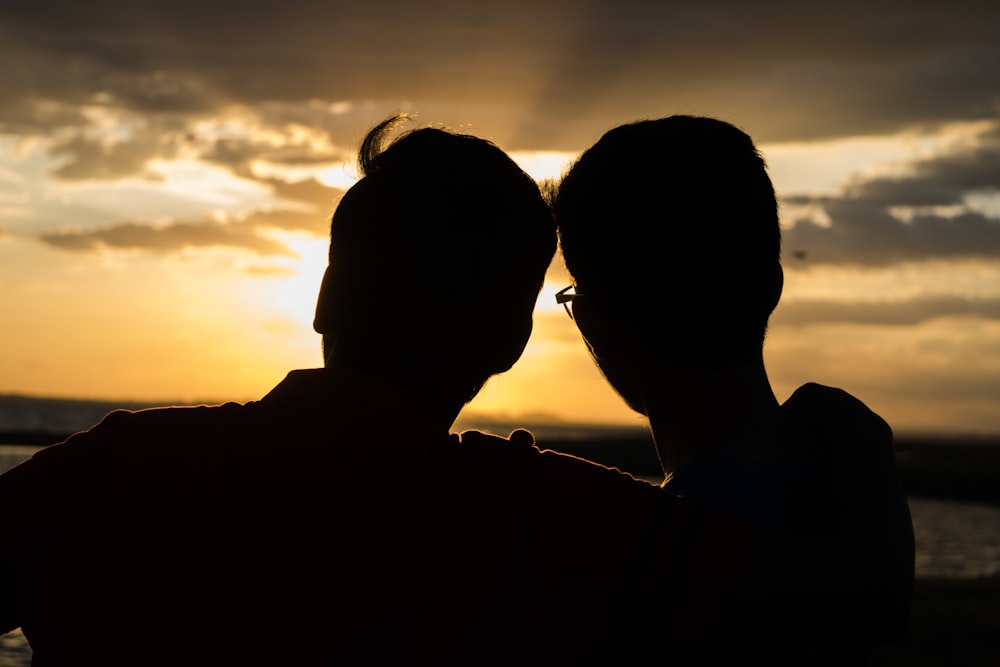 back view of couple silhouette during golden hour