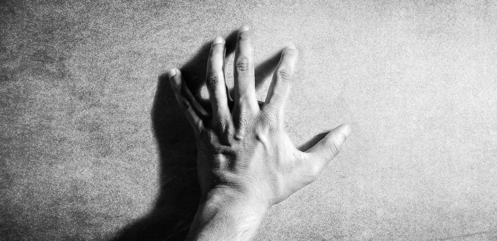 left human hand in grayscale photography