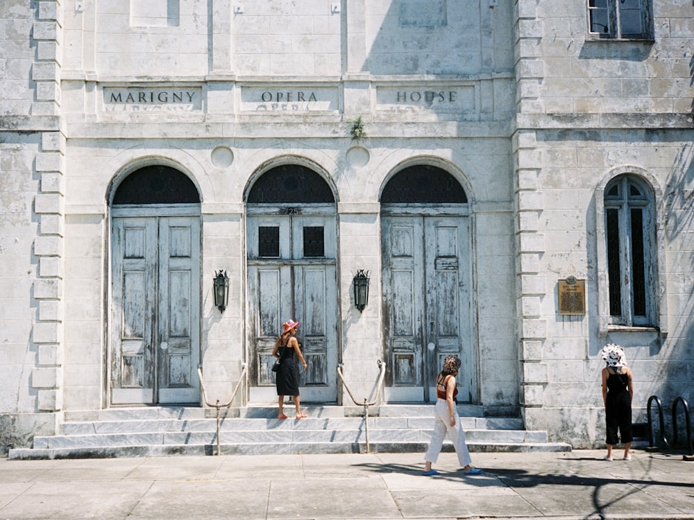 three women standing near building