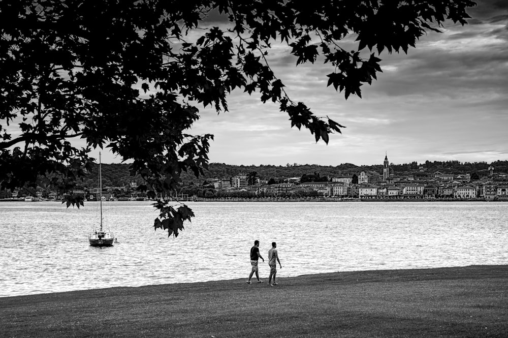 a couple of people that are standing in the grass