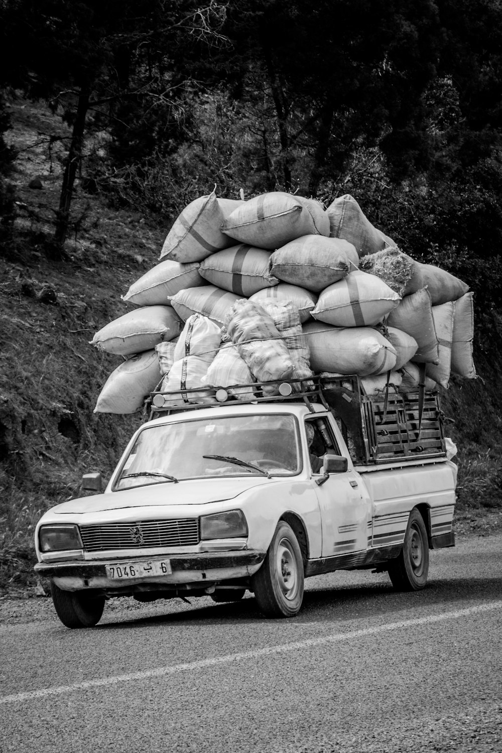 grayscale photography of pickup truck on road