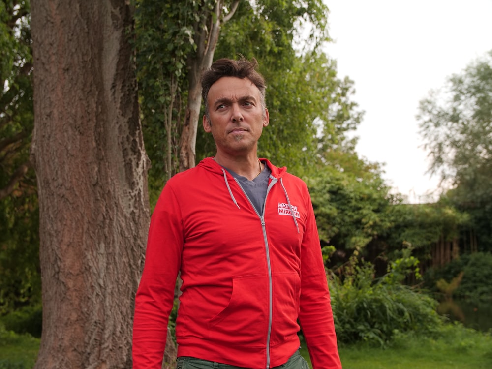 man wearing red zip-up jacket