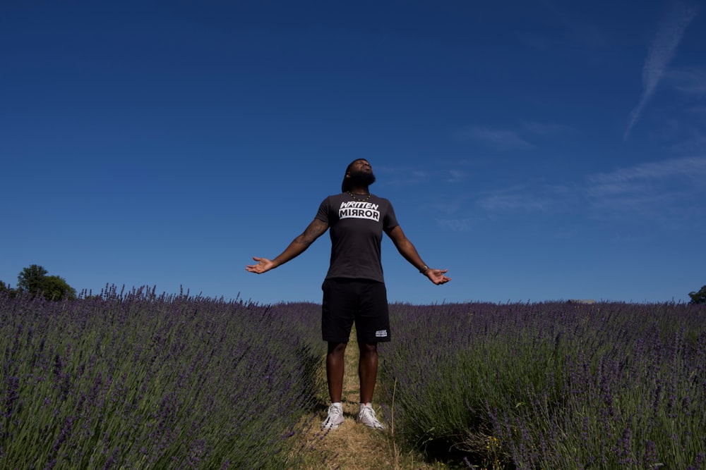 man standing front of purple flower field