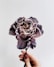 person holding gray and white petaled flower