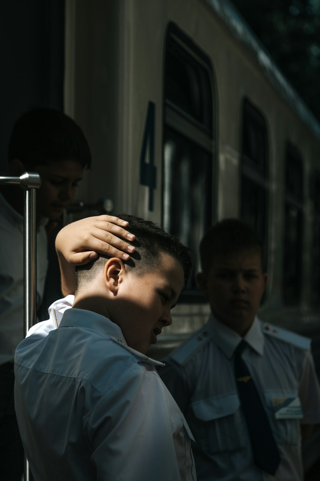 three boys wearing white dress shirt