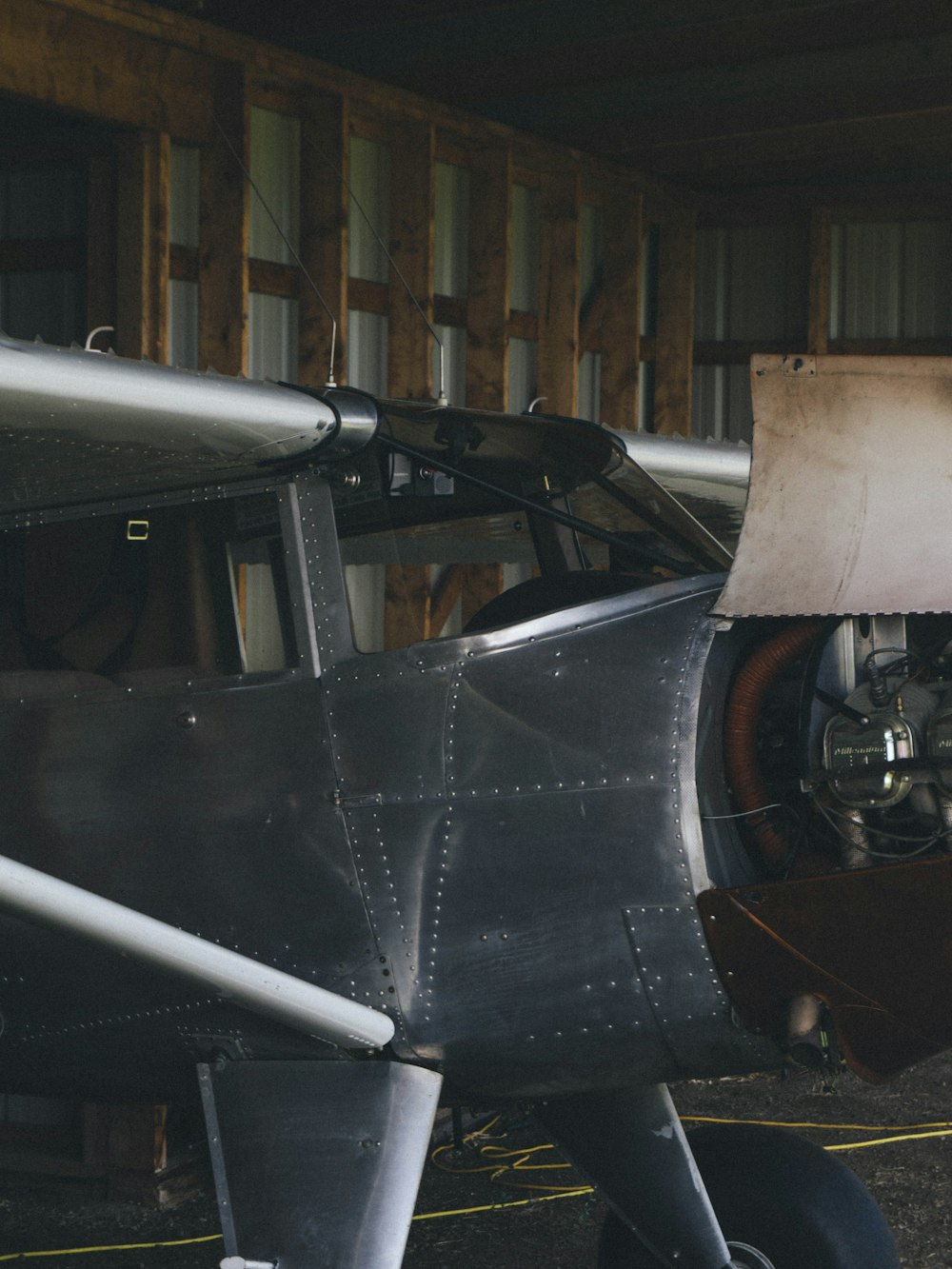 a small propeller plane sitting in a hangar