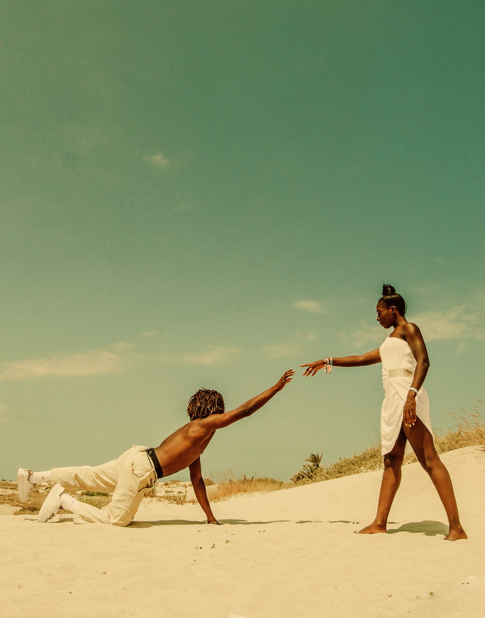 man reaching for woman's hand