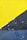 A close-up view of a wall with a textured surface, featuring a bright yellow section on the top and a rugged, dark blue area on the bottom. The paint appears cracked and peeling at the boundary where the two colors meet.