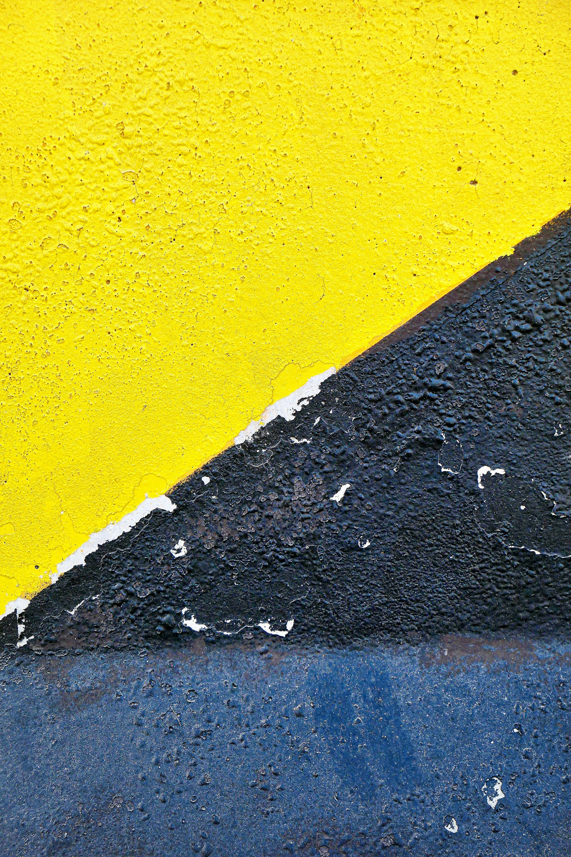 Close-up of a newly painted interior wall with crisp lines and vibrant color, contrasted with the previous worn-out surface.