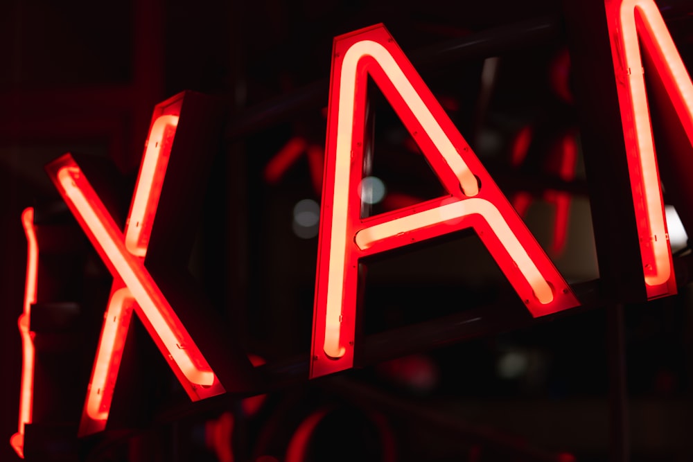 a close up of a neon sign that says ajax