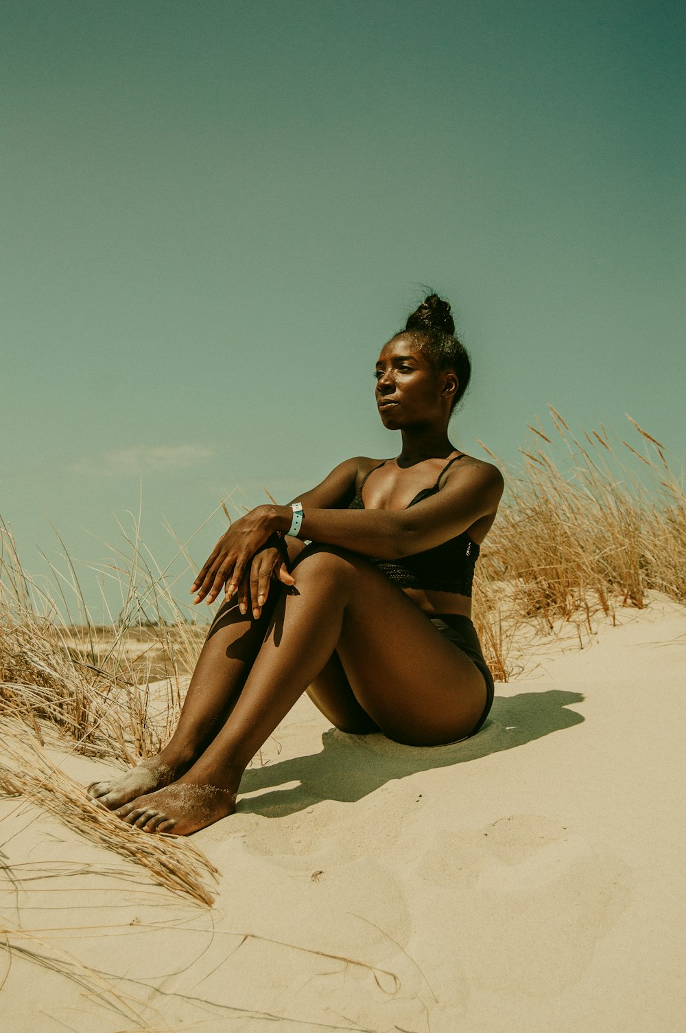 woman sitting on sand