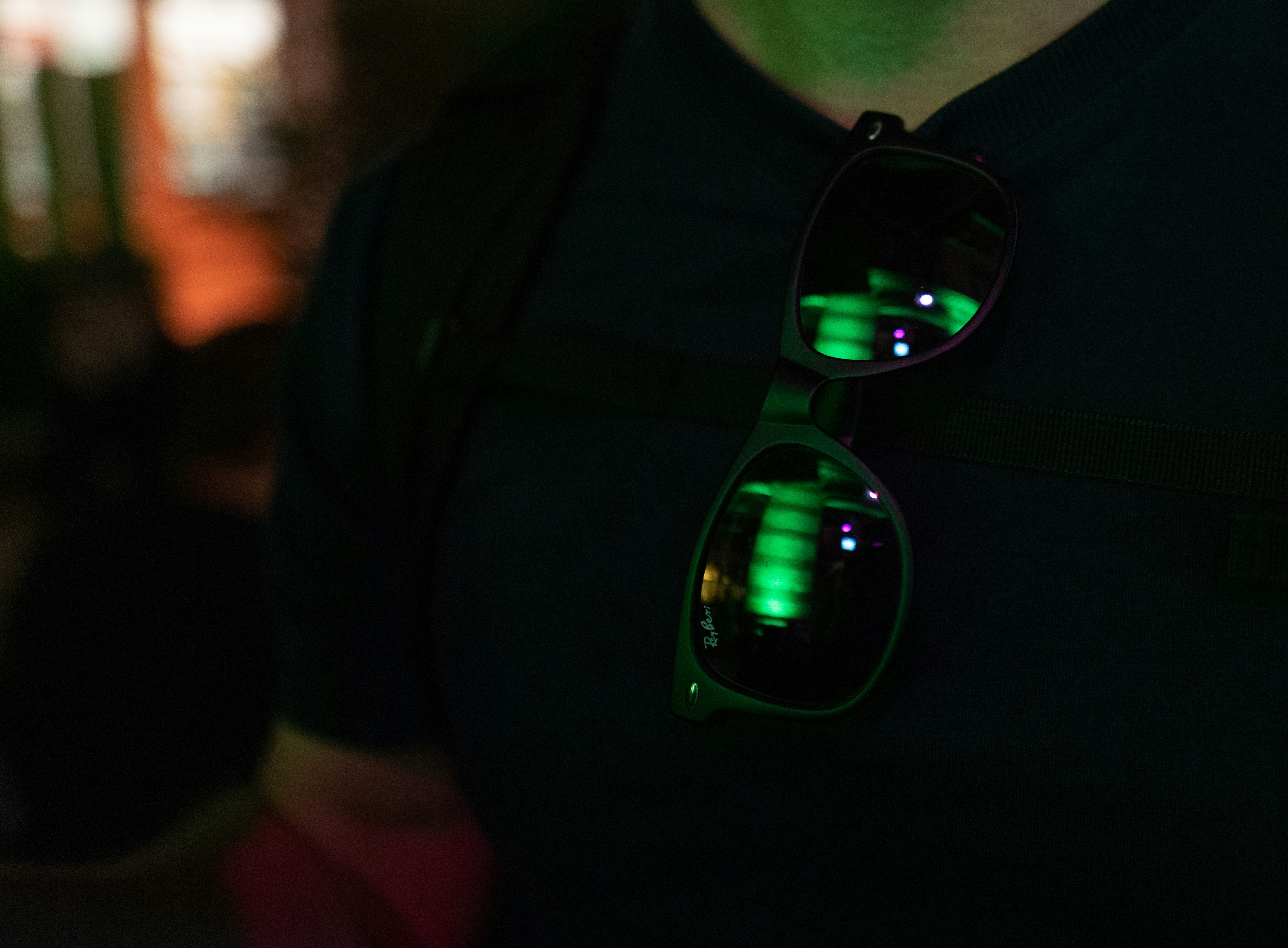 a man wearing a pair of green light up sunglasses