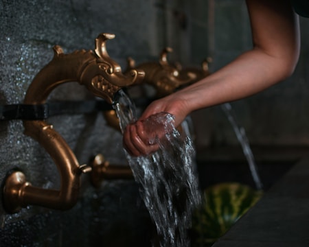 Artisan hands installing golden touch sanitary ware in a home.
