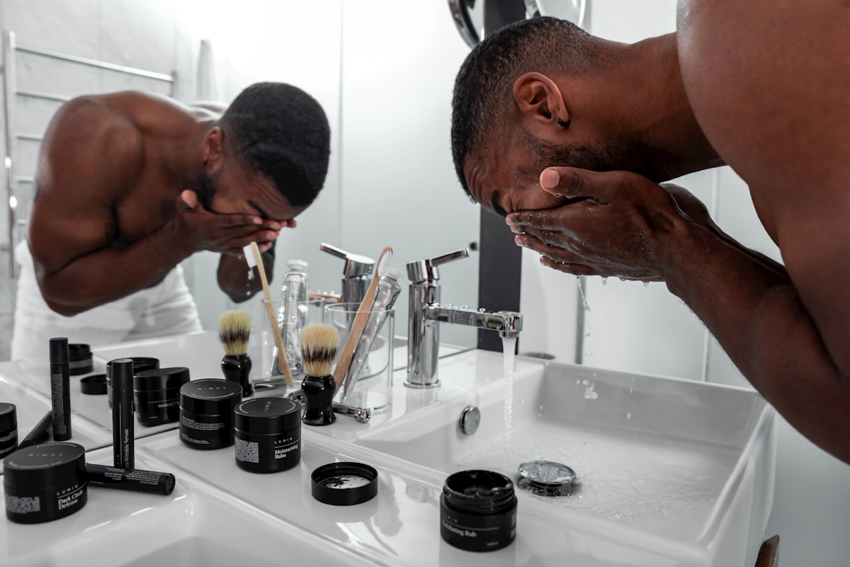 A man standing at a bathroom sink during a morning grooming routine
