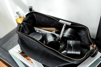 black leather bag with cream containers