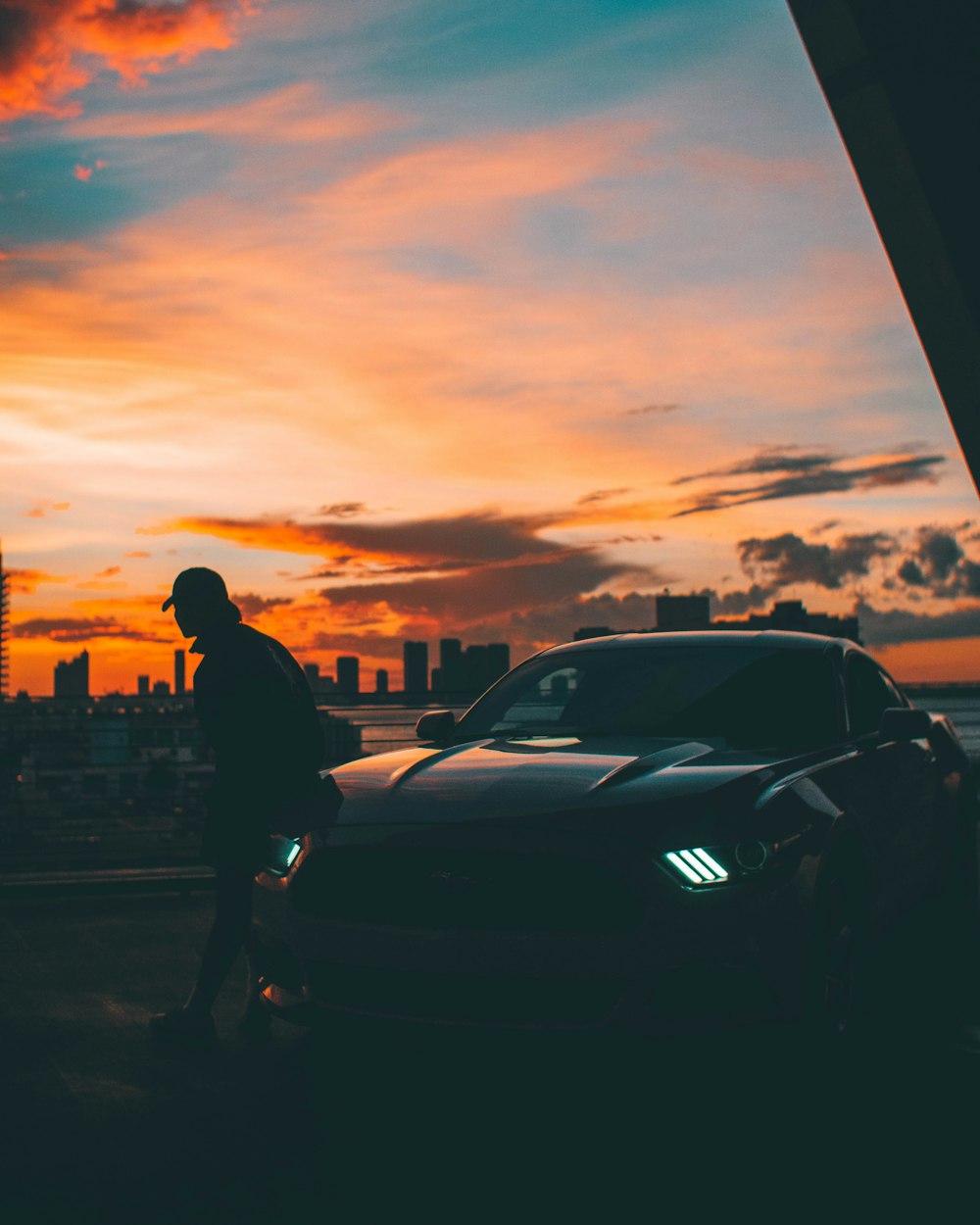 man leaning on Ford Mustang coupe