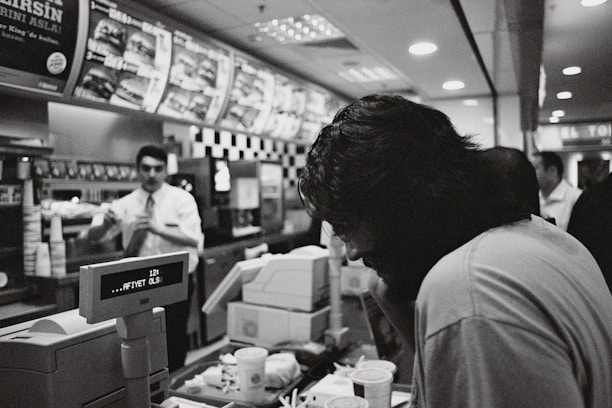 Close-up of a fast food counter with happy customers and efficient staff.