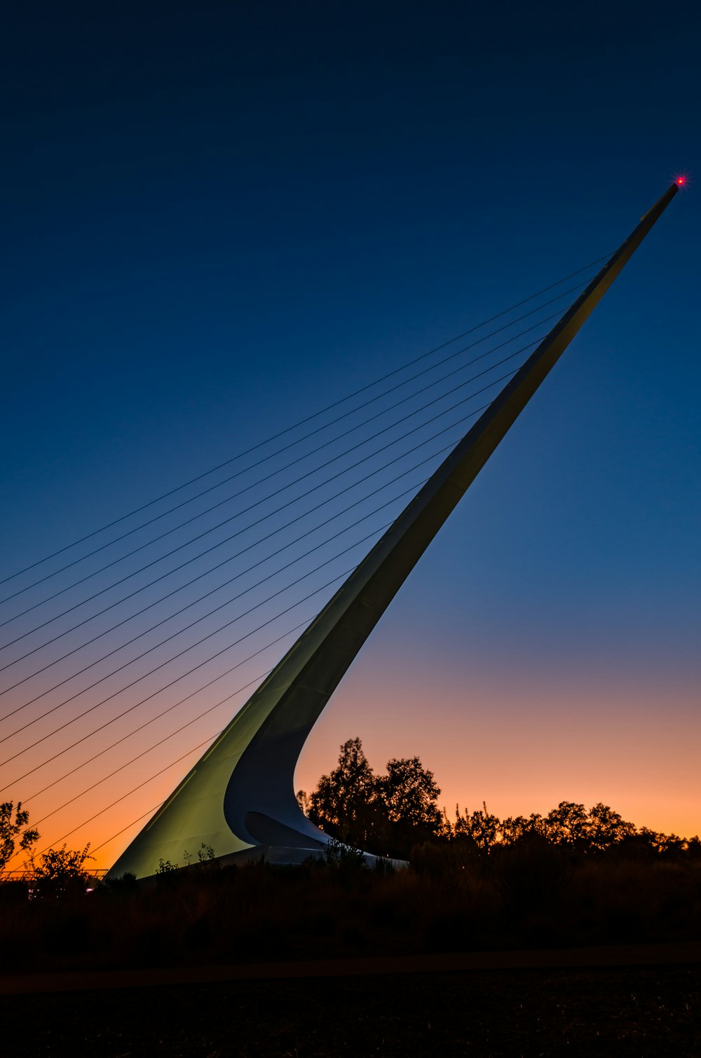 a very tall bridge with a bright light on it's side