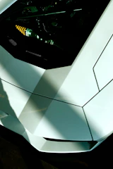 Close-up image of a sports car with deep charcoal window tint reflecting sunlight.