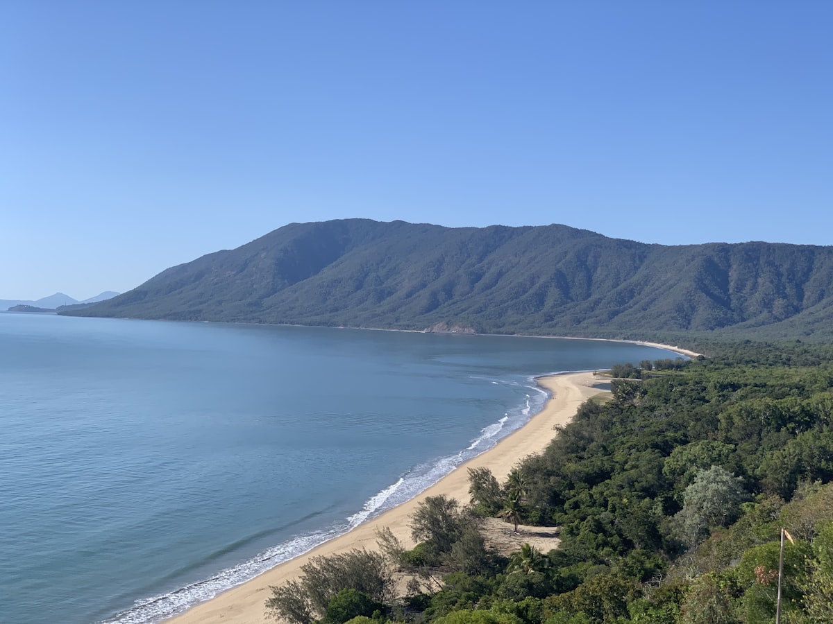 Port Douglas — Four Mile Beach with rainforest-covered hills and the Coral Sea in far north Queensland