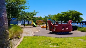 Colorful inflatable playground with happy children playing outdoors on a sunny day