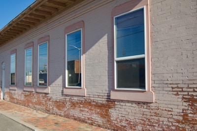 A clean brick facade after professional softwash cleaning on a sunny day.