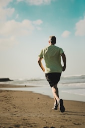 man running on seashore