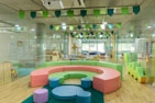 A vibrant playroom scene featuring children happily playing with various creative play sets.