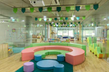 A bright, welcoming workshop space filled with kids and colorful toys.
