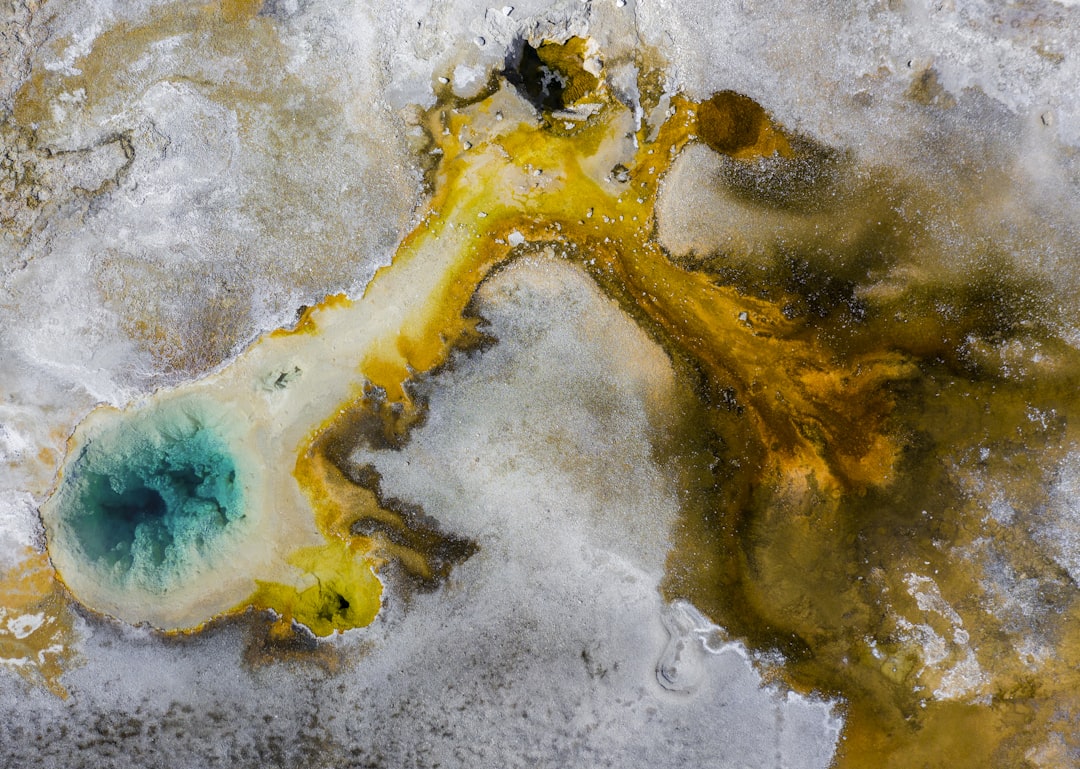 an aerial view of a yellow and blue substance, One of the best closeups i got of a thermal pool at Yellowstone National 