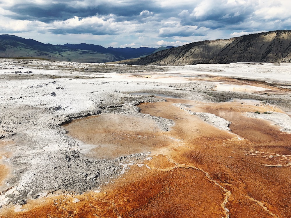 a view of a barren area with mountains in the background