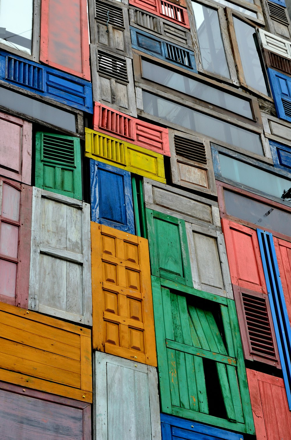 assorted-colored wooden doors and windows